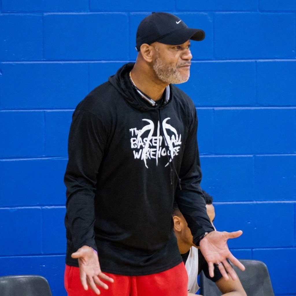 Coach portrait against the blue wall before tip-off