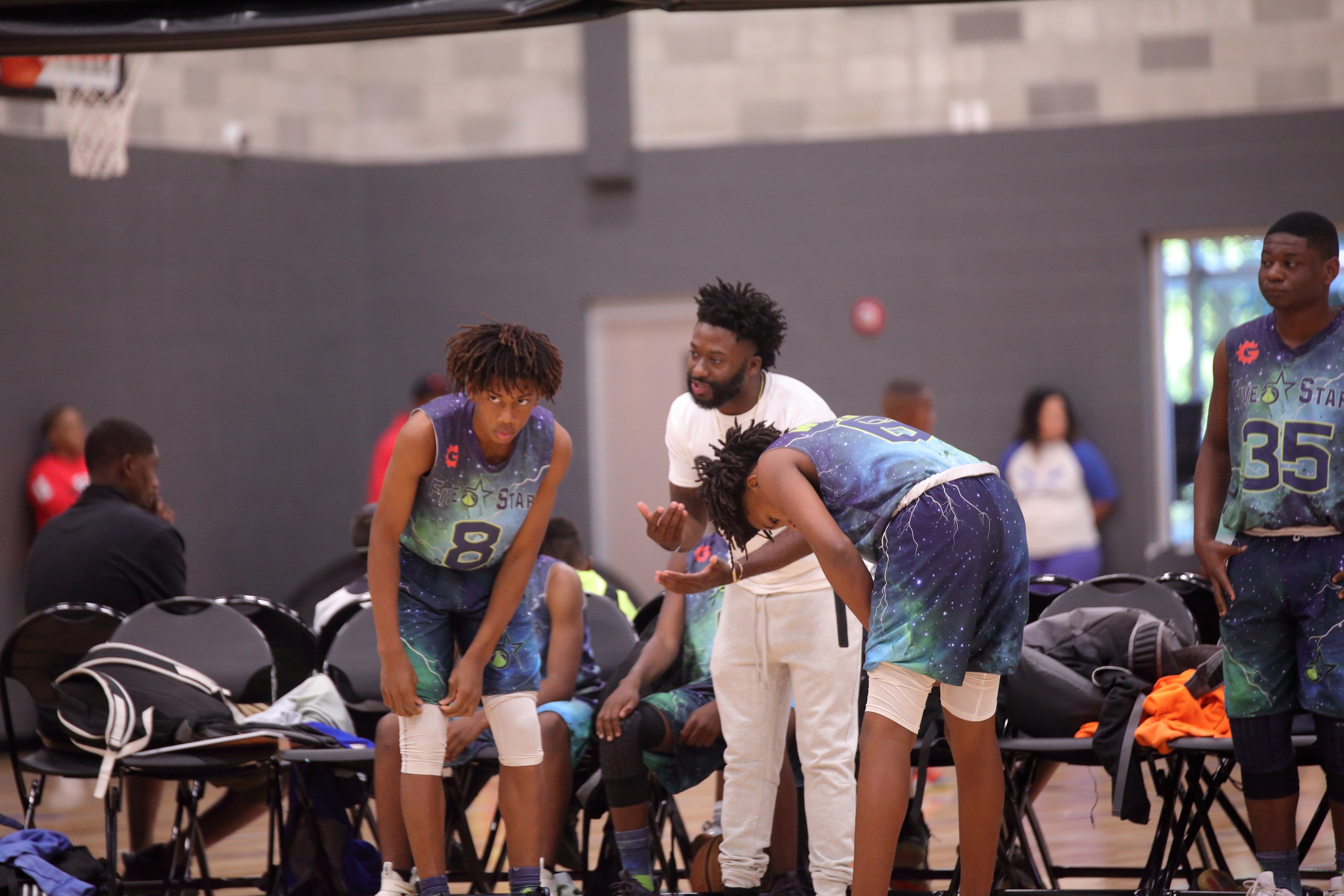 Coach giving instructions to players on the bench