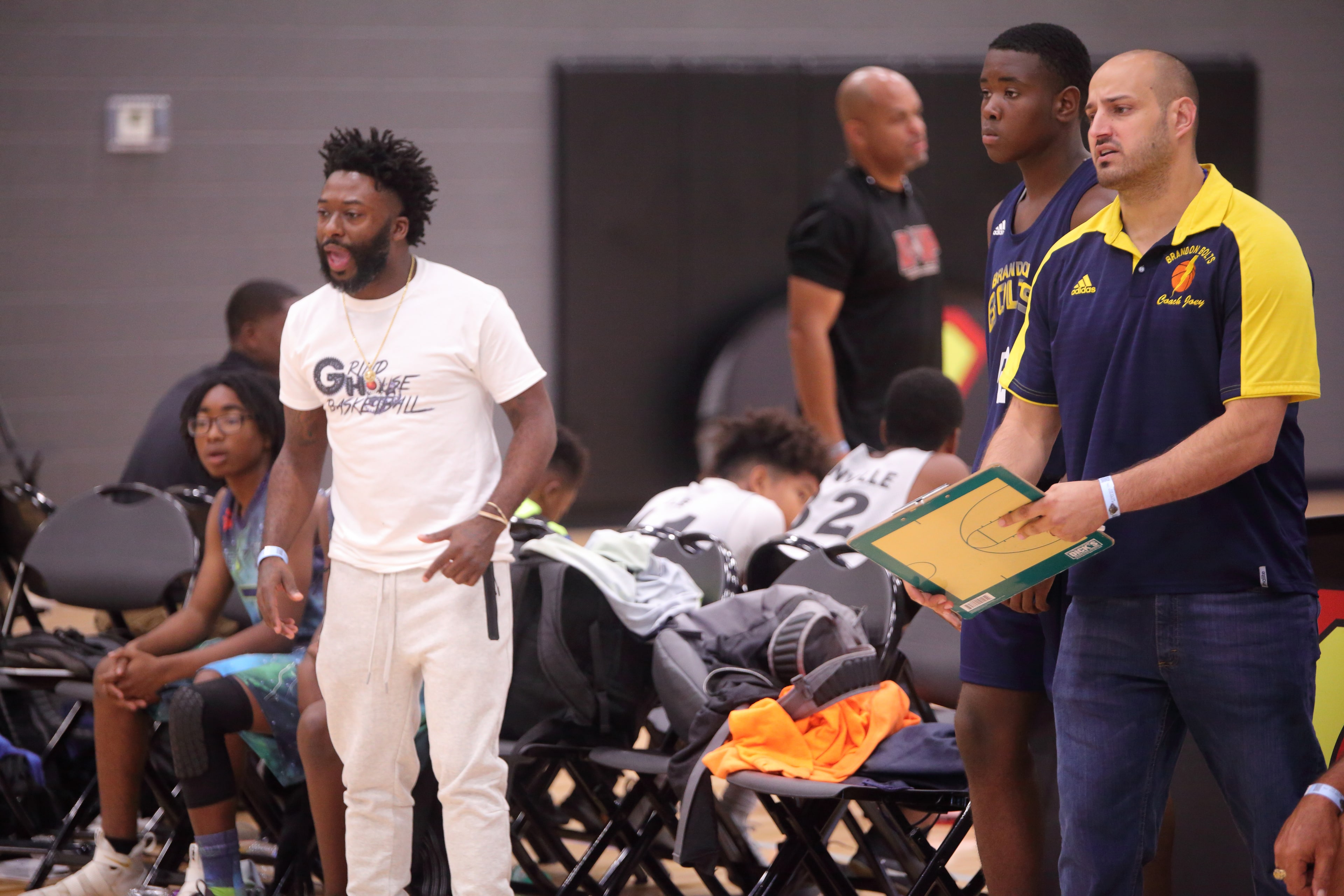 Two coaches running the sideline mid-game