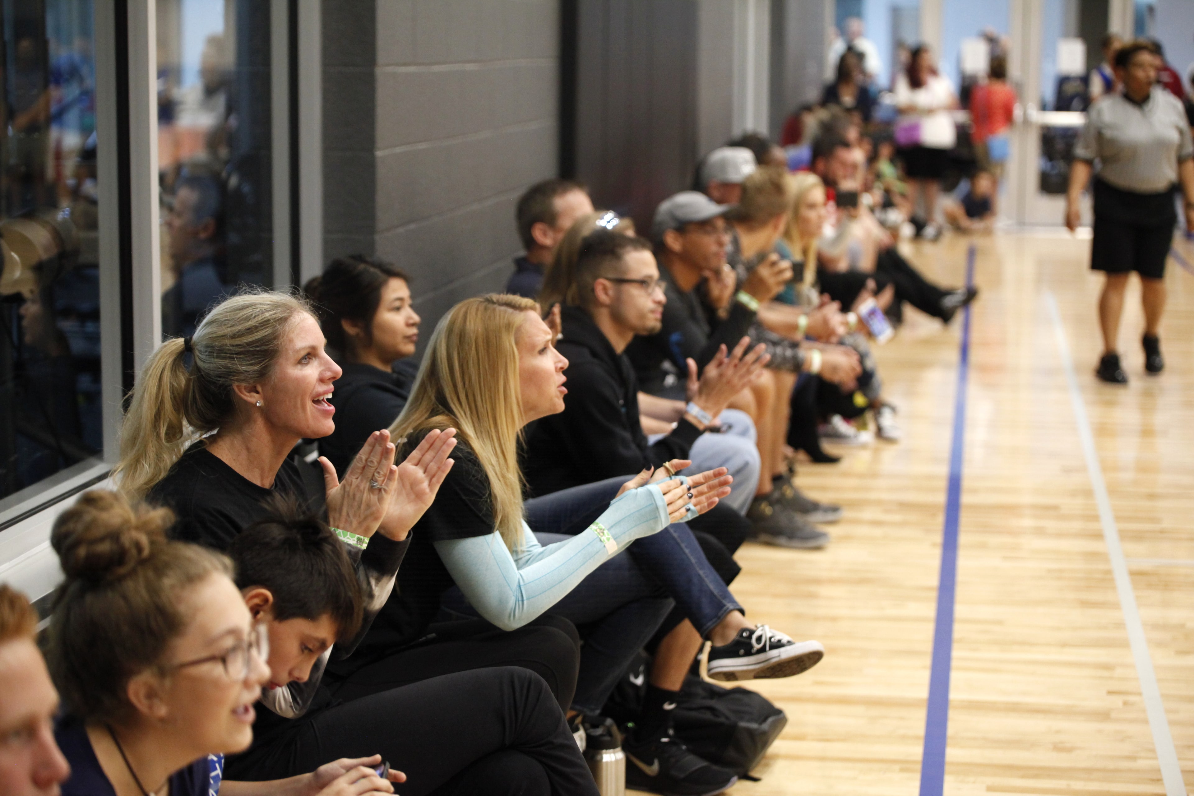 Spectators clapping along the sideline