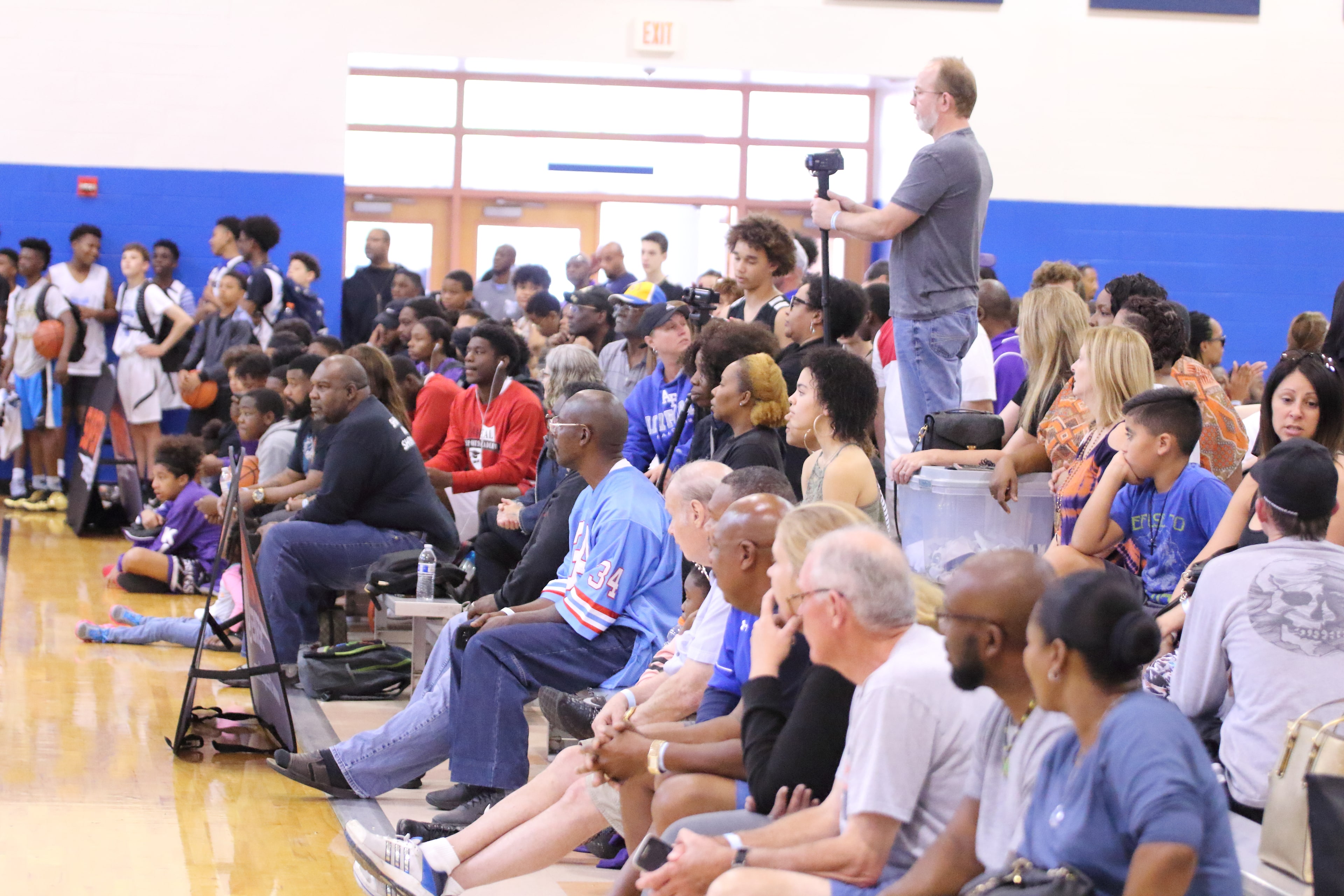 Front row of spectators packed along the floor