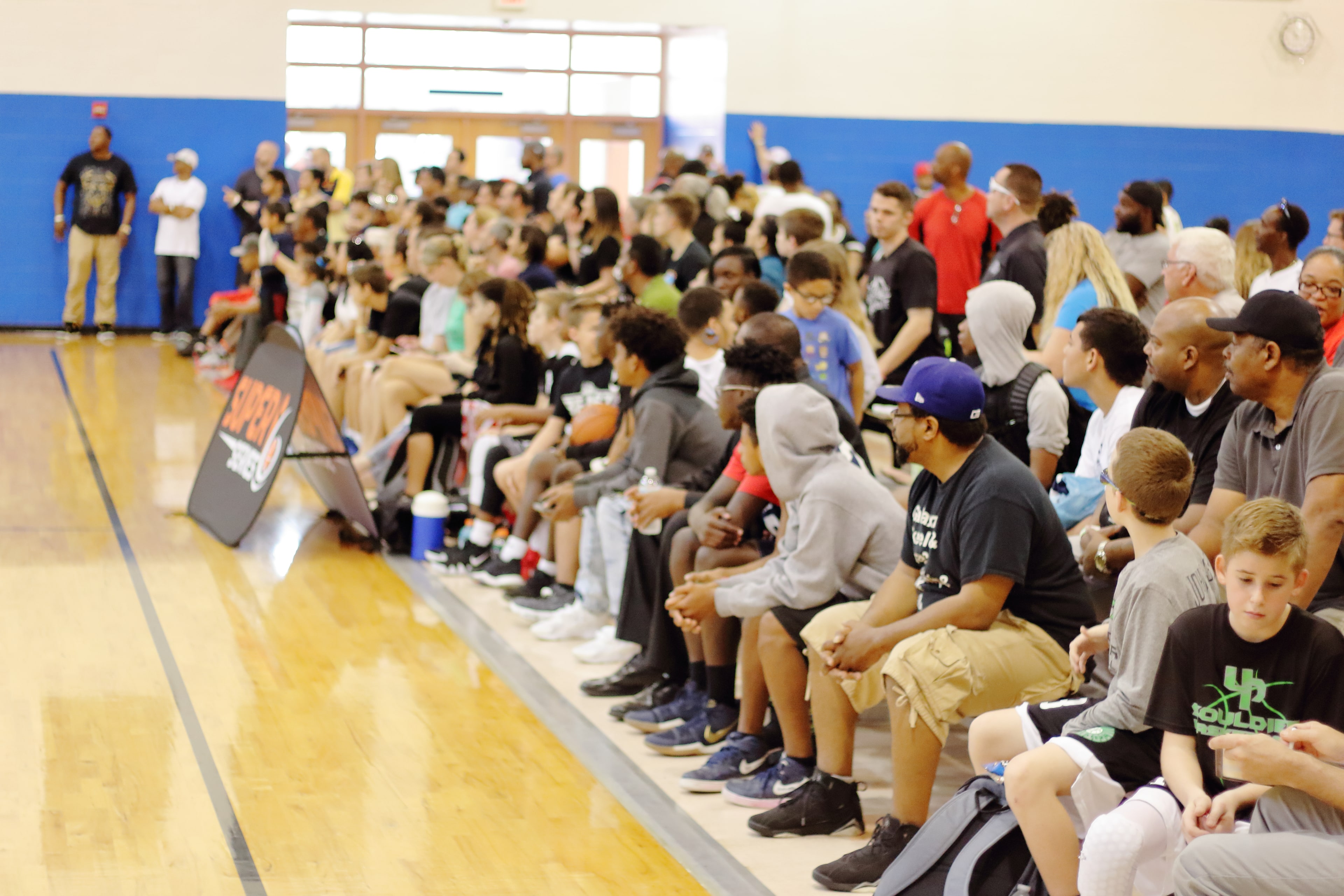 Wide angle of the packed gym sideline