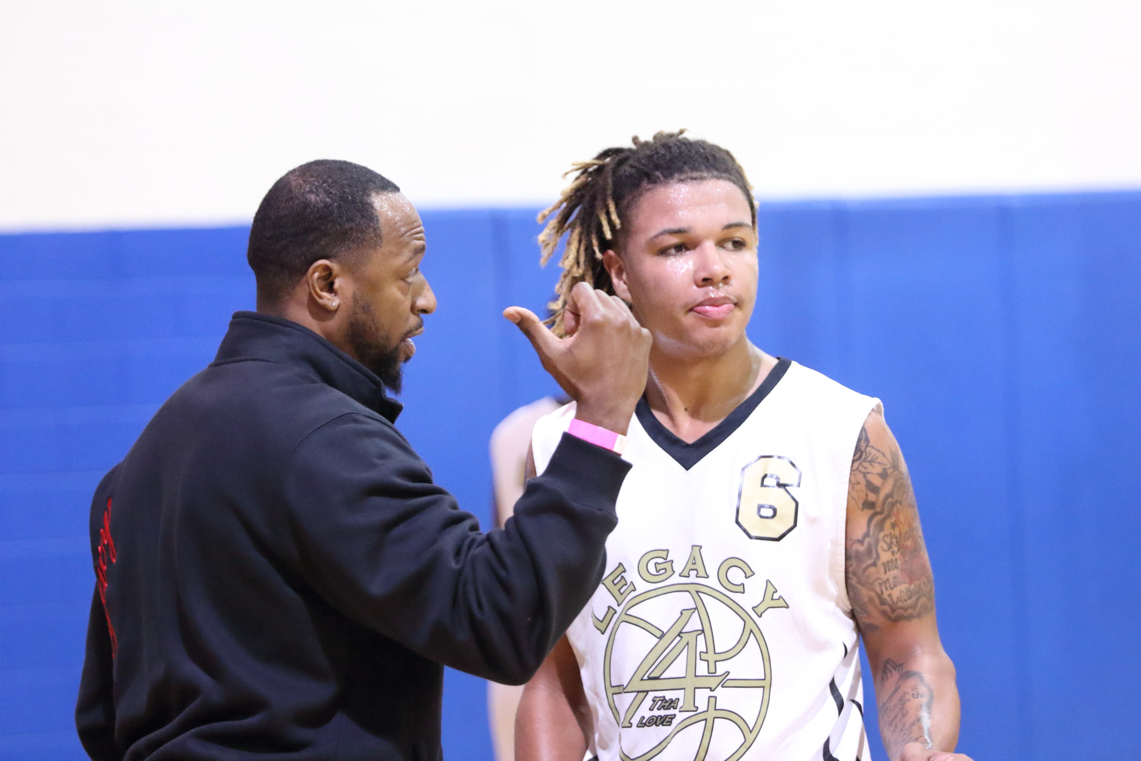 Coach making a point to a Legacy player on the sideline